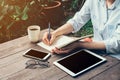 Young business woman hand with pencil writing on notebook. Woman