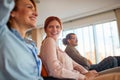 A young business woman is having a good time at a business lecture in the conference room with her colleagues. Business, people, Royalty Free Stock Photo