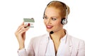 Young business woman in headset holding house model Royalty Free Stock Photo