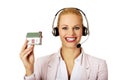 Young business woman in headset holding house model Royalty Free Stock Photo