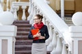 Young business woman hold in hand folder against office building on street near stairway Royalty Free Stock Photo