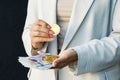 Young business woman holding British pounds and bitcoin in hands, close up of female hands with cash equivalents