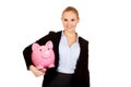 Young business woman holding piggybank