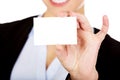 Young business woman holding small empty paper card Royalty Free Stock Photo