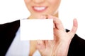 Young business woman holding small empty paper card Royalty Free Stock Photo