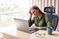 Young pretty business woman in a hopeless situation on her laptop Royalty Free Stock Photo