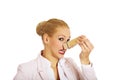 Young business woman with huge clothespin on her nose. Stinks concept