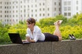 Young business woman kicks off her shoes and casualy works on la Royalty Free Stock Photo