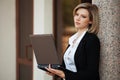 Young business woman with laptop at office building Royalty Free Stock Photo