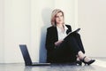 Young business woman with laptop sitting at office building Royalty Free Stock Photo