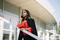 Young business woman leaning on railing outside office Royalty Free Stock Photo