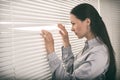 Young business woman looking out a window Royalty Free Stock Photo