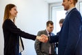 Young business woman and man in formal wearing shaking hands foeground view.