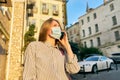 Young business woman in medical protective mask talking on smartphone outdoors Royalty Free Stock Photo