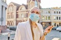 Young business woman in medical protective mask talking on smartphone Royalty Free Stock Photo