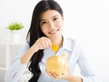 Young business woman with piggybank