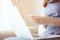 Young business woman plaid shirt using on cell phone during rest in office.