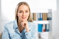 Portrait of young attractive business woman in an office Royalty Free Stock Photo