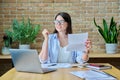 Young business woman reading an important letter, rejoicing at good news Royalty Free Stock Photo