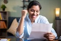 Young business woman reading paper letter feeling overjoyed and enjoying by good news clenched fist - Concept of new Job offer or