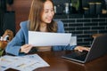 young business woman reading report document compare with laptop computer Royalty Free Stock Photo