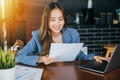 young business woman reading report document compare with laptop computer Royalty Free Stock Photo