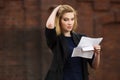 Young business woman reading a tax letter in city street Royalty Free Stock Photo