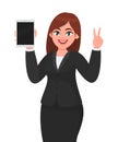 Young business woman showing or holding a brand new digital tablet computer and making or gesturing victory, v, peace, two sign. Royalty Free Stock Photo