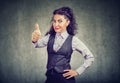 Young business woman showing thumbs up gesture