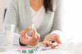 Young business woman sick in the office, hand holding pills Royalty Free Stock Photo