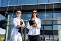 Young business woman signing contract outside business center in big city Royalty Free Stock Photo