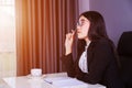 Business woman sitting at the desk and thinking to her work Royalty Free Stock Photo