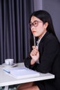 Business woman sitting at the desk and and thinking to her work Royalty Free Stock Photo