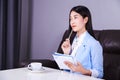 Business woman sitting at the desk and thinking to her work Royalty Free Stock Photo