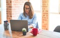 Young business woman sitting at desk working using computer laptop, modern executive girl at the office