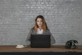 Young business woman sitting at her own desk Royalty Free Stock Photo
