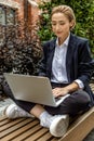 Young business woman sitting in a lotus pose and working on laptop Royalty Free Stock Photo