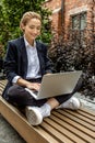 Young business woman sitting in a lotus pose and working on laptop Royalty Free Stock Photo