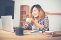 Young business woman sitting in office desk with cup of coffee r Royalty Free Stock Photo