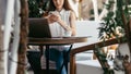 young business woman with a smartphone taking notes in her notebook. Royalty Free Stock Photo