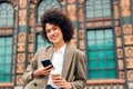 woman smiles happy with a mobile phone in the hand Royalty Free Stock Photo