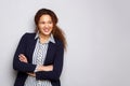 Young business woman smiling against gray background Royalty Free Stock Photo
