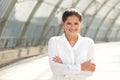 Young business woman smiling with arms crossed Royalty Free Stock Photo