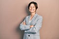 Young business woman smiling happy and confident with crossed arms standing over isolated background Royalty Free Stock Photo