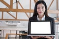 Young business woman smiling and showing blank laptop computer s Royalty Free Stock Photo