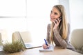 Young business woman speak at phone and make notice in notebook at office Royalty Free Stock Photo