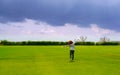 Young business woman standing backwards in a beautiful field landscape outdoors with raise hands arms to the sky