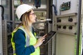 Young business woman standing in front of the control panel in the control room Royalty Free Stock Photo