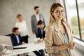 Young business woman standing in the office in front of her team Royalty Free Stock Photo