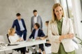 Young business woman standing in the office in front of her team Royalty Free Stock Photo